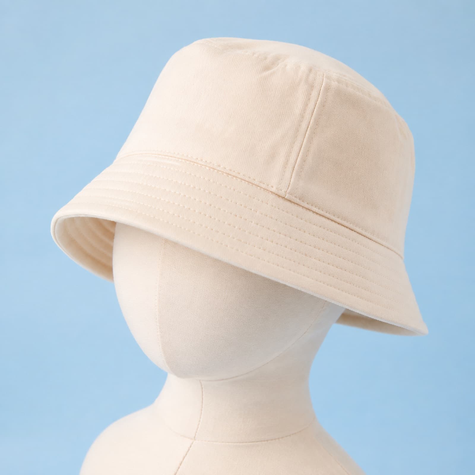 Cream cotton baby bucket hat with an all-round brim