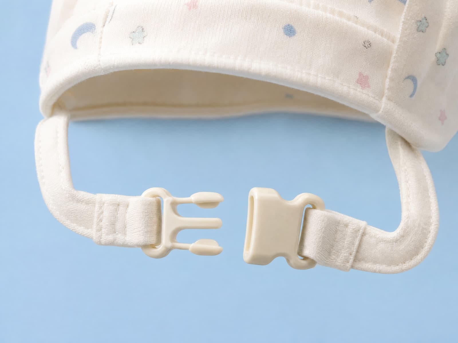 The same chin fastener separated into two halves with the strap slack
