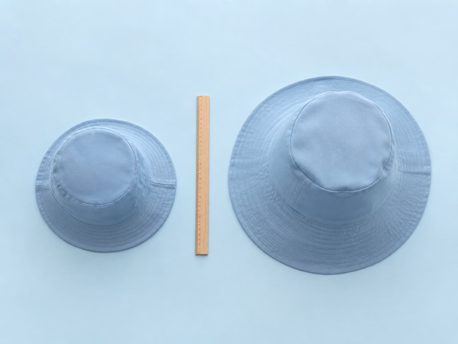 A kids bucket hat and an adult bucket hat laid side by side